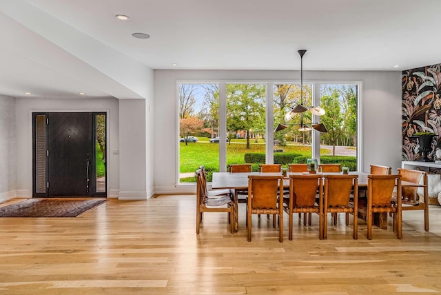 dining room featuring light wood-style floors, baseboards, and recessed lighting