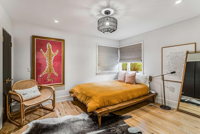 bedroom with recessed lighting, light wood-style flooring, and baseboards