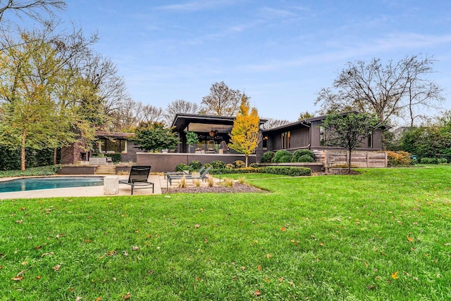 view of yard with a patio and an outdoor pool