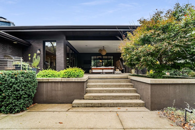 property entrance featuring brick siding