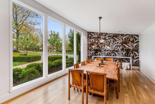 dining area featuring wallpapered walls, baseboards, an accent wall, light wood-type flooring, and recessed lighting