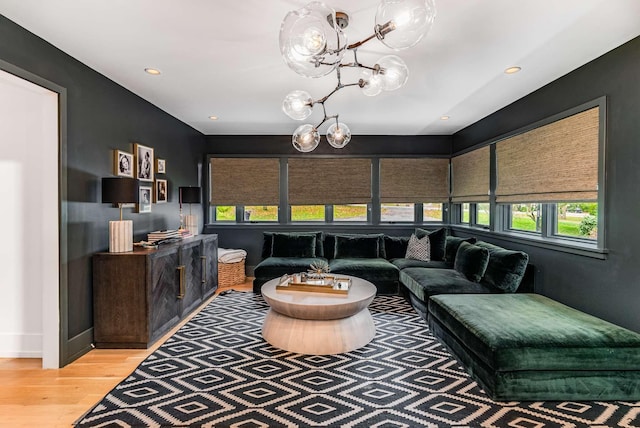 living room with an inviting chandelier, wood finished floors, and recessed lighting