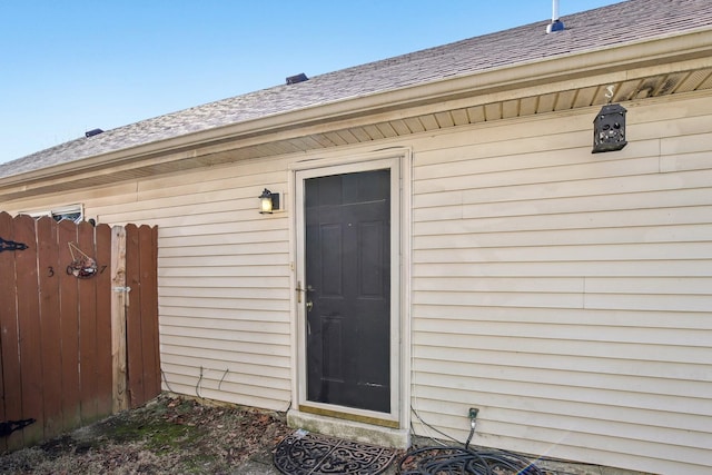 entrance to property with a shingled roof