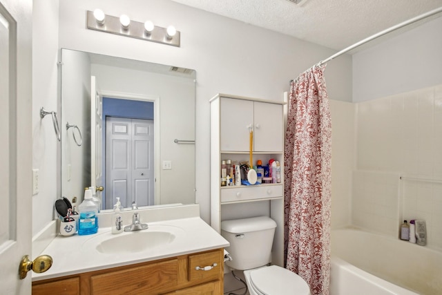 bathroom featuring shower / tub combo, vanity, toilet, and a textured ceiling