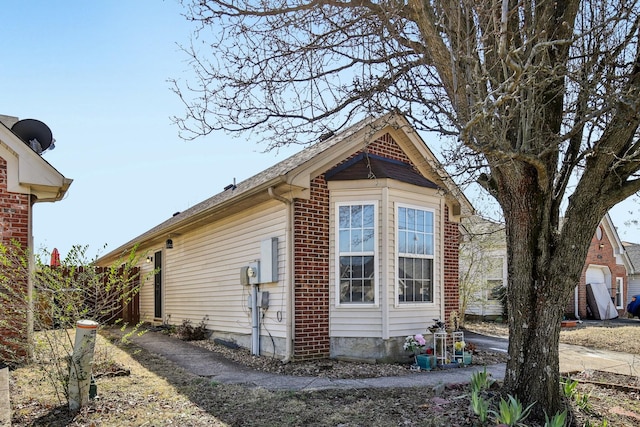 view of property exterior featuring brick siding