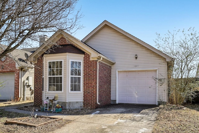 ranch-style house with concrete driveway, brick siding, a chimney, and an attached garage