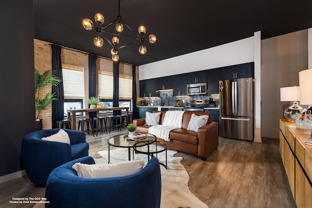 living room with a notable chandelier and wood finished floors