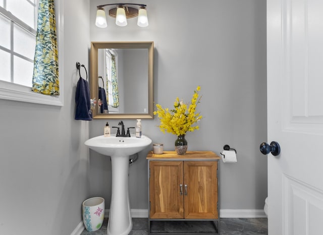 bathroom with baseboards and a wealth of natural light