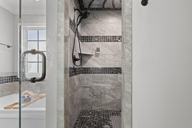 bathroom featuring ornamental molding, a tile shower, and a tub