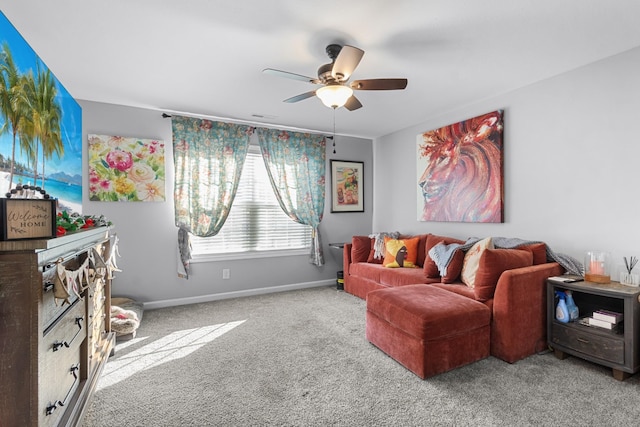 carpeted living room featuring a ceiling fan and baseboards