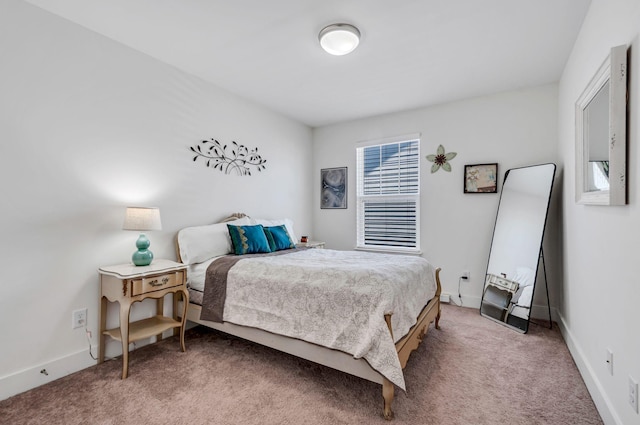 bedroom with light carpet and baseboards