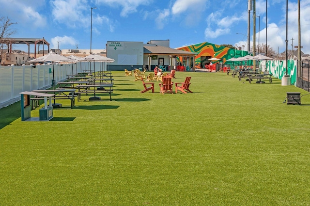 view of home's community featuring a yard and fence