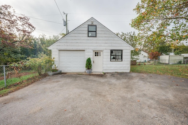 detached garage featuring fence