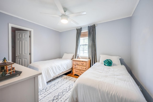 bedroom featuring wood finished floors, crown molding, and ceiling fan