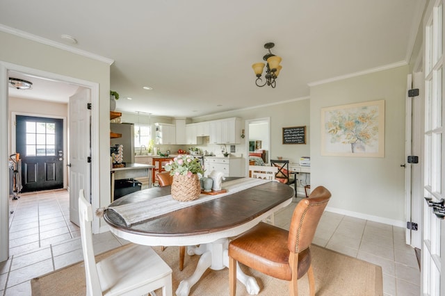 dining area featuring ornamental molding, light tile patterned flooring, a notable chandelier, and baseboards