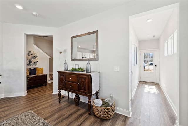 corridor with baseboards and dark wood-type flooring