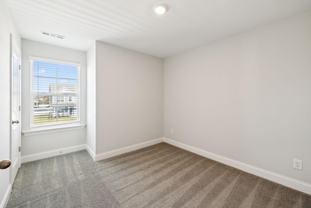 carpeted empty room with baseboards and visible vents