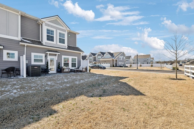 exterior space featuring a residential view, central AC, and fence