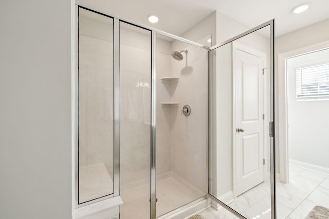 bathroom with a stall shower, recessed lighting, marble finish floor, and baseboards