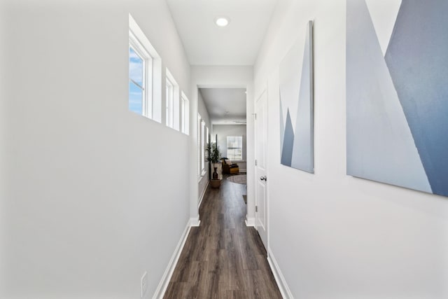 corridor featuring baseboards, dark wood-type flooring, and recessed lighting