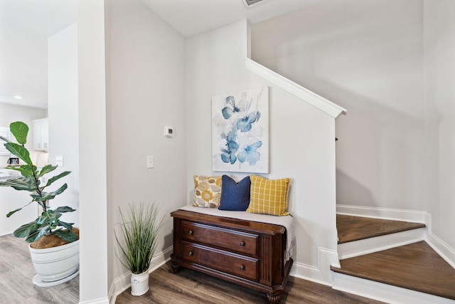 interior space with stairs, dark wood finished floors, and baseboards