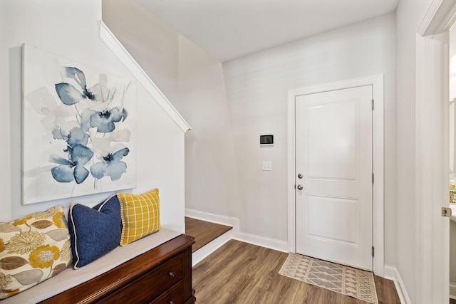 entryway with baseboards and wood finished floors