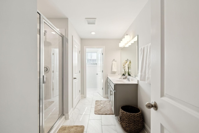 bathroom featuring visible vents, baseboards, marble finish floor, vanity, and a shower stall