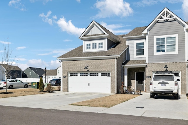 view of front of property featuring driveway, a shingled roof, a garage, and brick siding