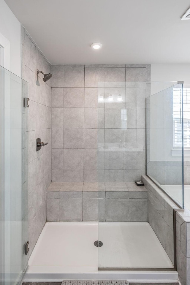 full bath with visible vents and a shower stall