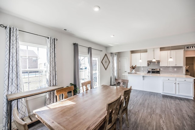 dining room featuring wood finished floors and visible vents