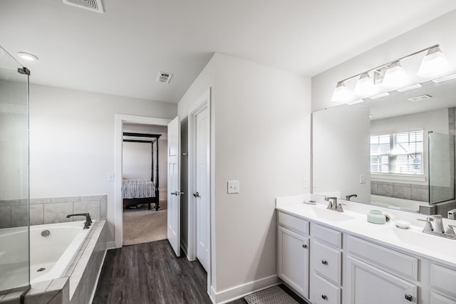 ensuite bathroom featuring double vanity, visible vents, a sink, and ensuite bathroom