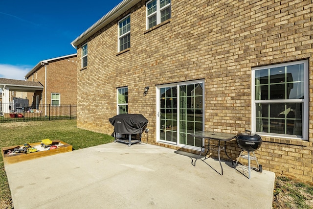 back of house with a patio area, brick siding, and fence