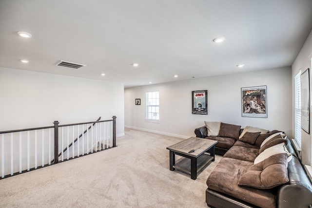 living room featuring recessed lighting, visible vents, light carpet, and baseboards