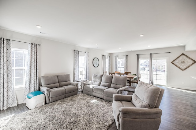 living room featuring baseboards, visible vents, dark wood-type flooring, and recessed lighting