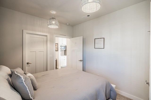 carpeted bedroom featuring baseboards and visible vents