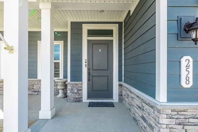 doorway to property with stone siding