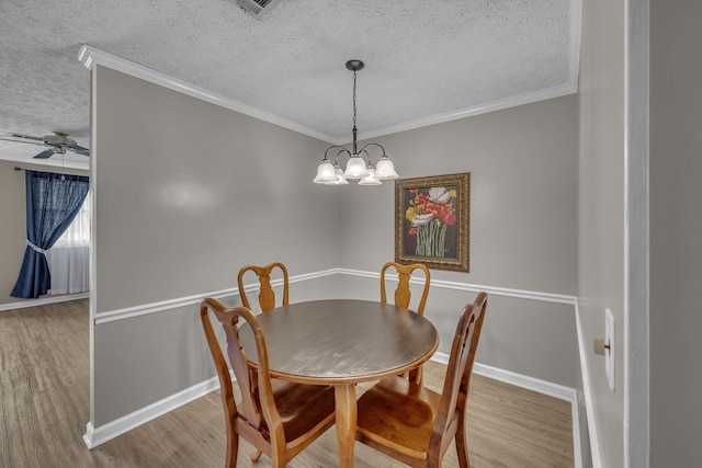 dining room featuring crown molding, a textured ceiling, and wood finished floors