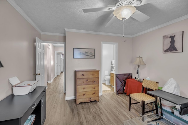 living area with a textured ceiling, a ceiling fan, baseboards, light wood finished floors, and crown molding