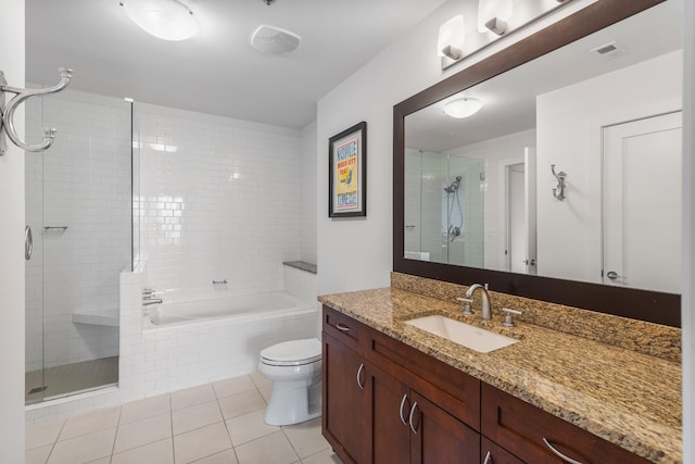 full bath with toilet, vanity, visible vents, tiled shower, and tile patterned floors