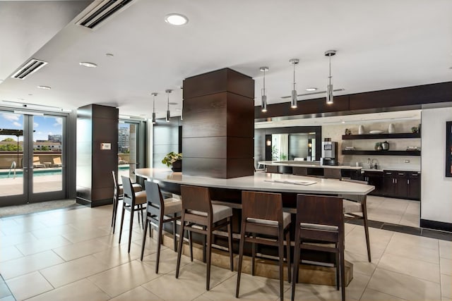 kitchen featuring hanging light fixtures, modern cabinets, light countertops, and visible vents