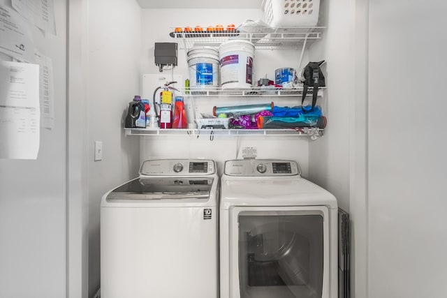 washroom featuring laundry area and washing machine and clothes dryer