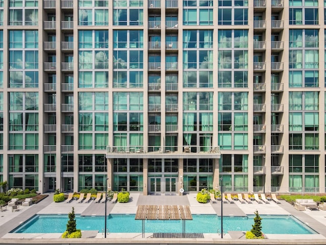 view of swimming pool featuring a hot tub