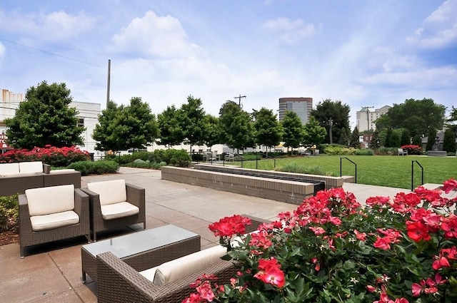 view of home's community with a yard, an outdoor hangout area, and a patio