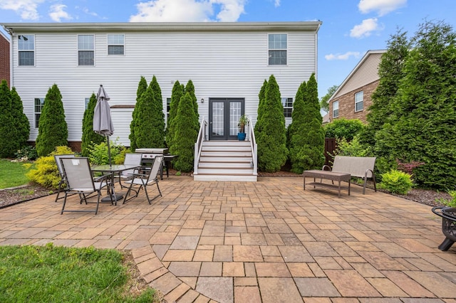 rear view of property with french doors and a patio area