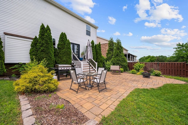 view of patio / terrace with a fire pit, fence, and grilling area