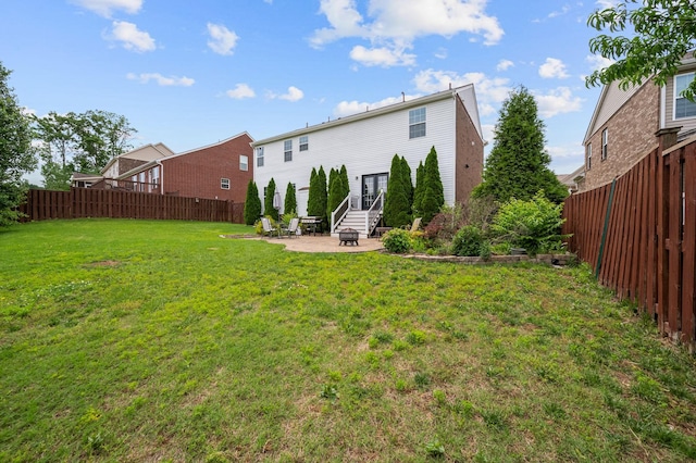 back of property featuring a yard, a patio area, and a fenced backyard