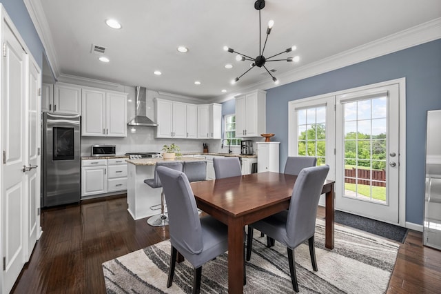 dining area with dark wood-type flooring, visible vents, and crown molding