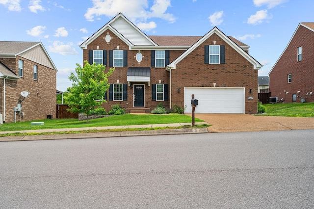 view of front facade featuring an attached garage, a front yard, concrete driveway, and brick siding