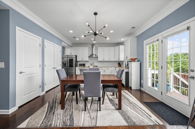 dining space featuring a notable chandelier, visible vents, ornamental molding, dark wood-type flooring, and baseboards