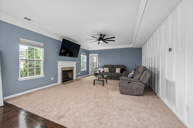 living room featuring plenty of natural light, visible vents, and baseboards